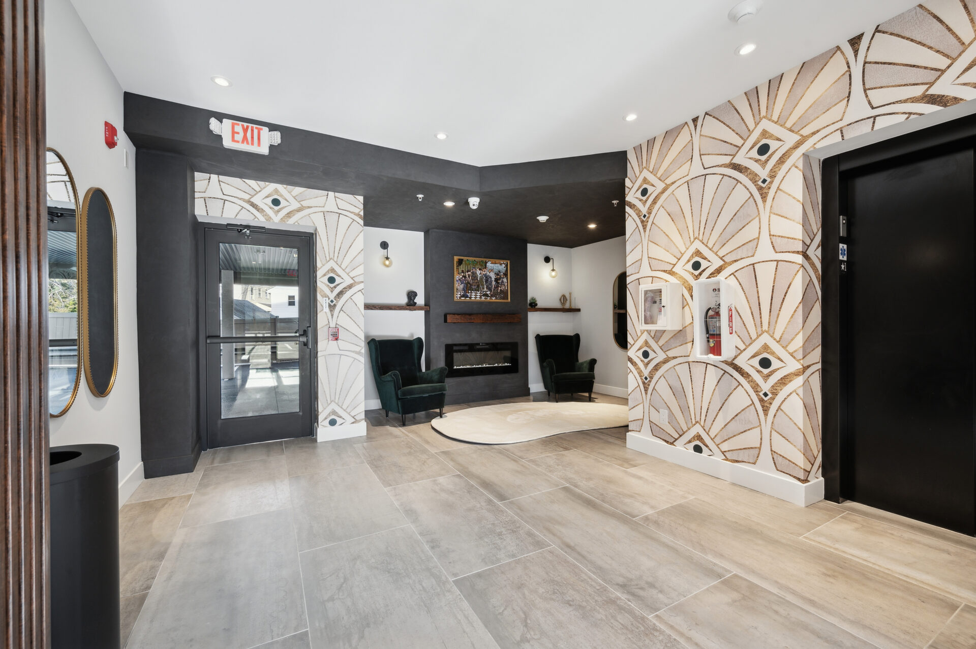 The Lane Jenkintown lobby fireplace seating area with velvet wingback chairs and curated artwork